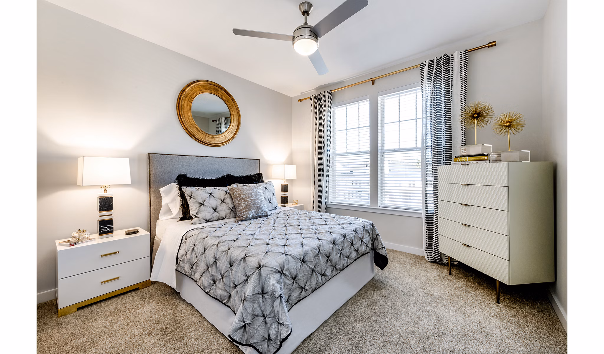 Spacious bedroom with soft lighting and modern decor in Greystar luxury apartments