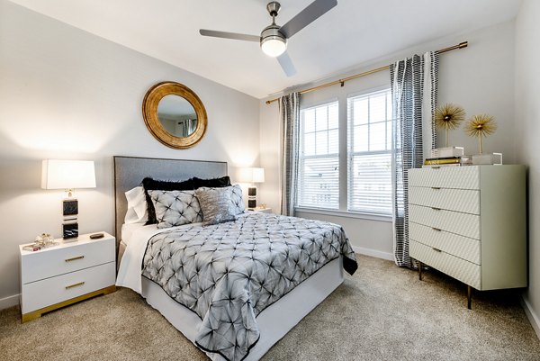 Spacious bedroom with soft lighting and modern decor in Greystar luxury apartments