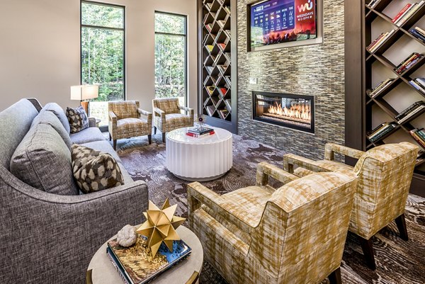 Modern living room with a cozy fireplace and stylish furniture in luxury apartments