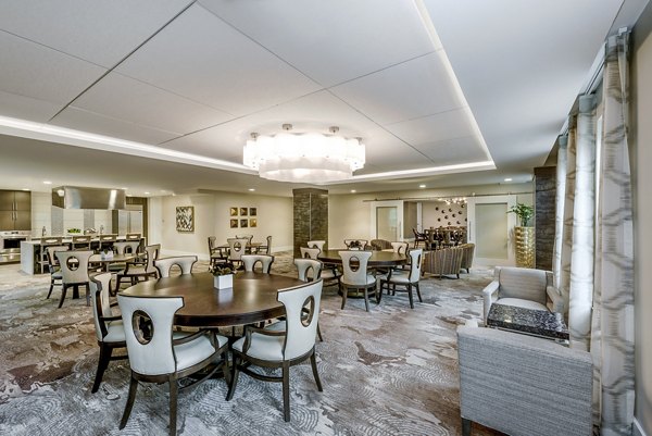 Elegant clubhouse with modern decor at Overture Fair Ridge Apartments, featuring spacious seating and communal areas