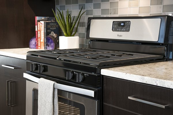 Modern kitchen with stainless steel appliances in Greystar luxury apartments