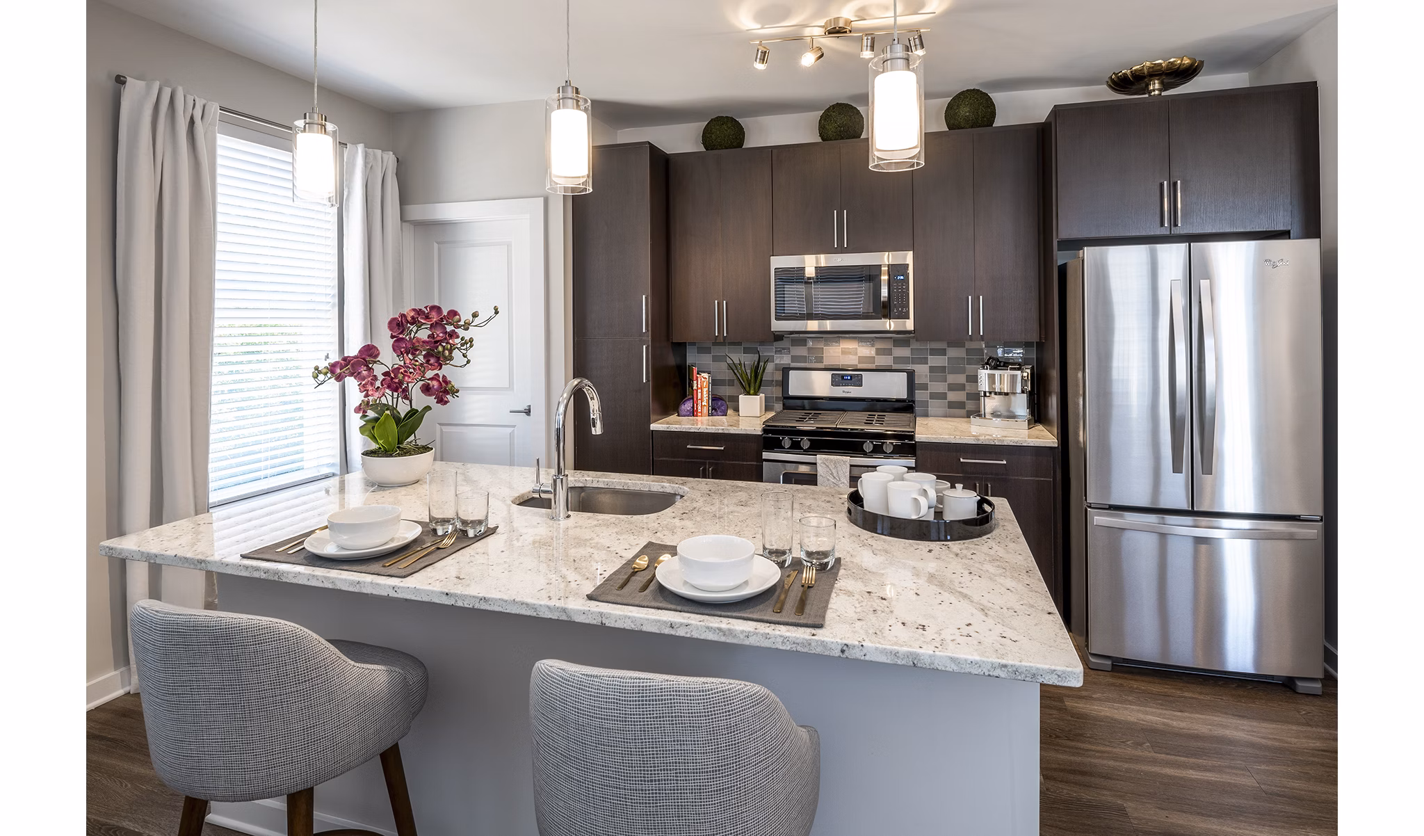 Modern kitchen with sleek countertops and stainless steel appliances at Overture Fair Ridge Apartments