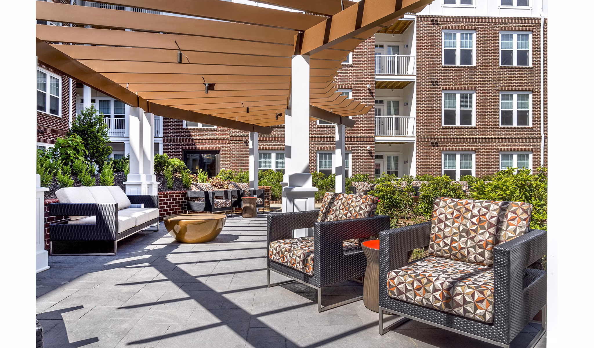 Private balcony with vibrant outdoor seating at Overture Fair Ridge Apartments