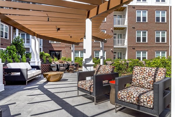 Private balcony with vibrant outdoor seating at Overture Fair Ridge Apartments
