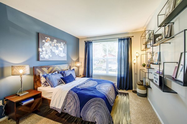 Bedroom featuring modern decor and large windows at Avana One Six Four Apartments