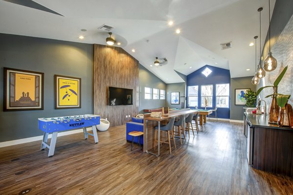 Game room featuring pool table and arcade games at Avana One Six Four Apartments, offering entertainment and relaxation for residents