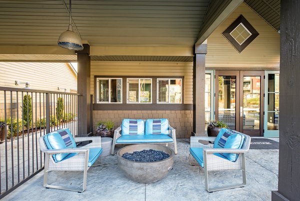 Modern patio with outdoor seating at Avana One Six Four Apartments, ideal for relaxing and entertainment in a luxurious setting