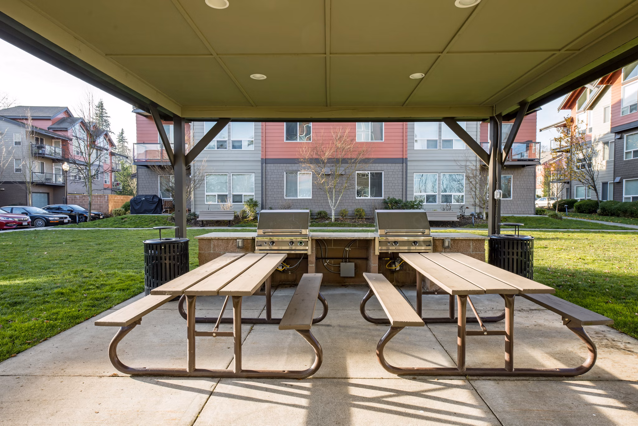Spacious outdoor patio area with modern seating at Avana One Six Four Apartments