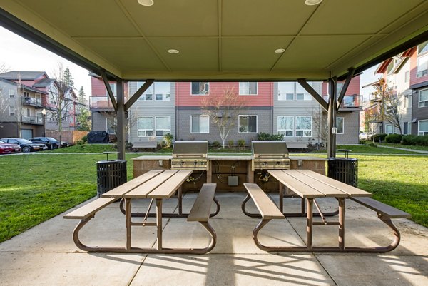 Spacious outdoor patio area with modern seating at Avana One Six Four Apartments