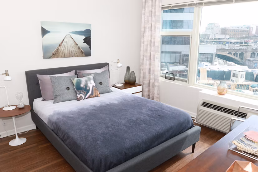 Luxurious bedroom with modern furnishings at 3 Journal Square Apartments