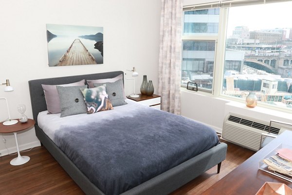 Luxurious bedroom with modern furnishings at 3 Journal Square Apartments