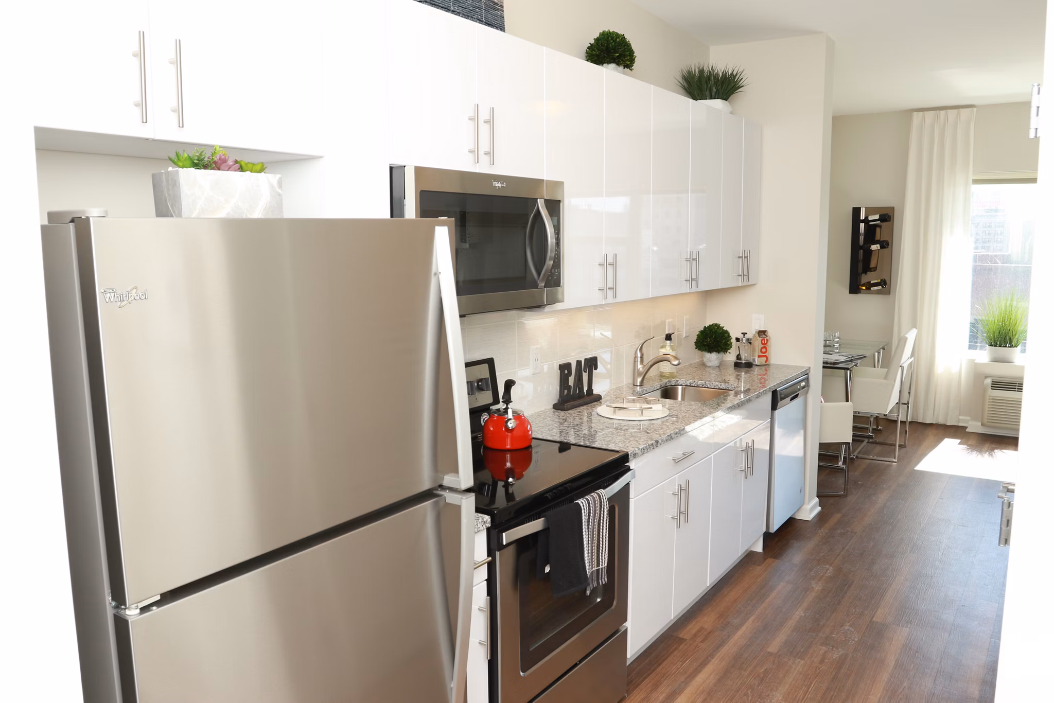 Modern kitchen with sleek cabinetry and stainless steel appliances at 3 Journal Square Apartments, luxury living in Jersey City
