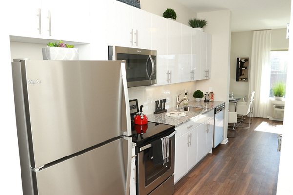 Modern kitchen with sleek cabinetry and stainless steel appliances at 3 Journal Square Apartments, luxury living in Jersey City