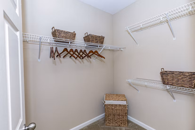 Andover at Johns Creek: Modern bedroom closet with built-in shelving and ample storage in Greystar's luxury apartments