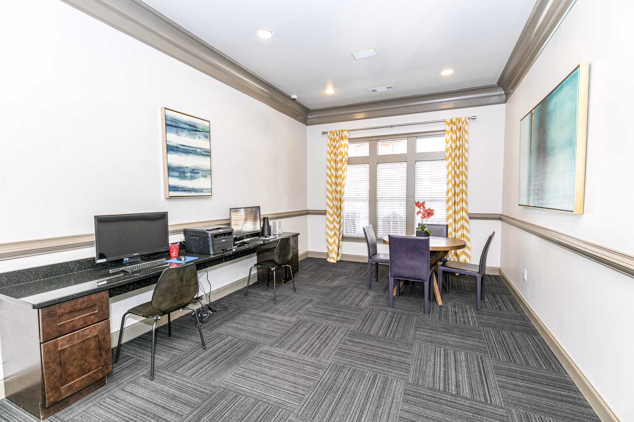 Modern business center with spacious workstations at Andover at Johns Creek Apartments clubhouse