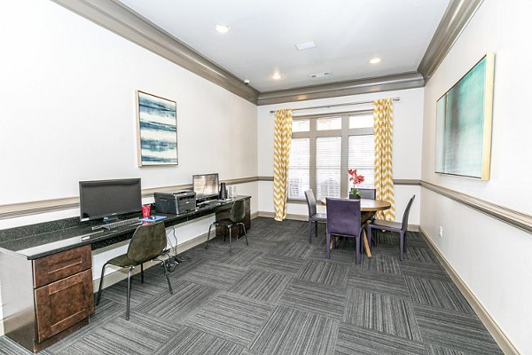 Modern business center with spacious workstations at Andover at Johns Creek Apartments clubhouse