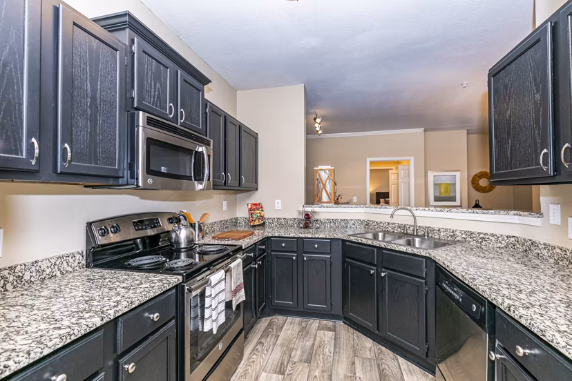 Modern kitchen featuring sleek countertops and stainless steel appliances at Andover at Johns Creek luxury apartments