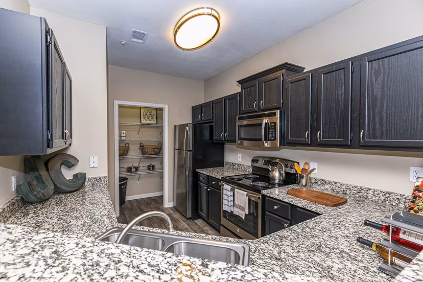 Modern kitchen with stainless steel appliances in Andover at Johns Creek Apartments