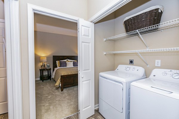 Laundry room featuring modern washers and dryers at Andover at Johns Creek Apartments