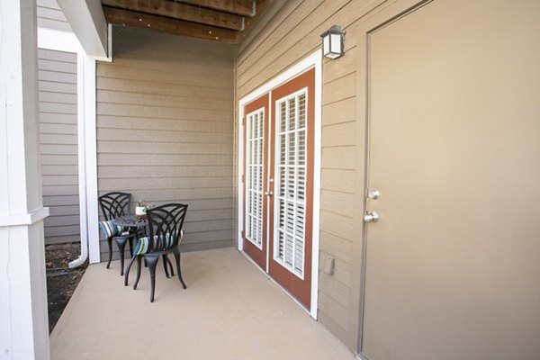 Spacious patio/balcony with lush greenery views at Andover at Johns Creek Apartments