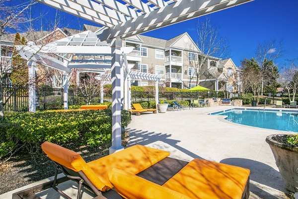 Luxurious pool cabana with shaded seating at Andover at Johns Creek Apartments, perfect for relaxation and socializing