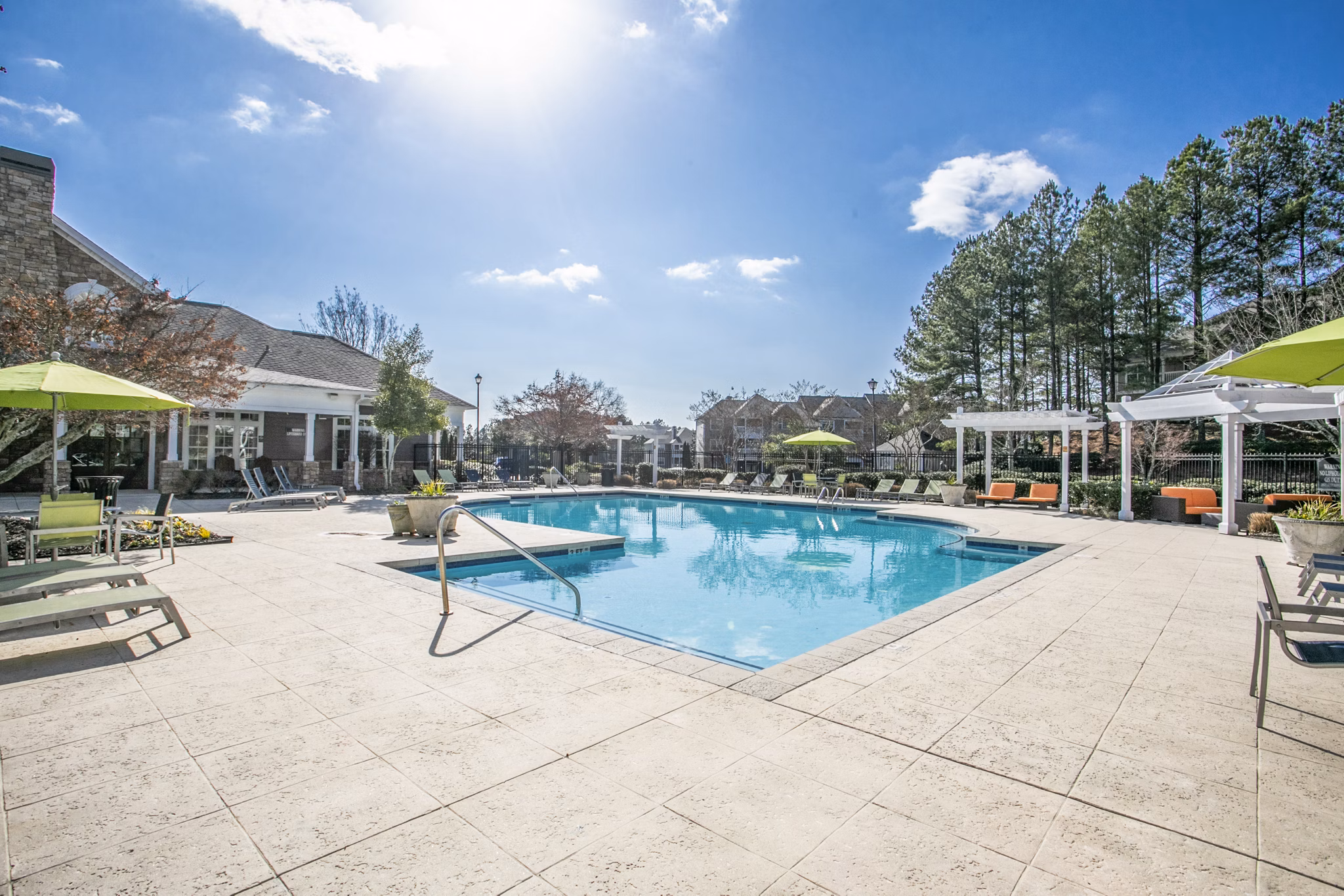 Sparkling outdoor pool at Andover at Johns Creek Apartments providing resort-style relaxation