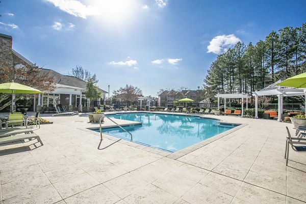 Sparkling outdoor pool at Andover at Johns Creek Apartments providing resort-style relaxation
