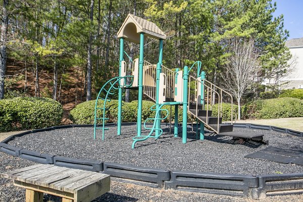 Colorful playground with slides and swings at Andover at Johns Creek Apartments