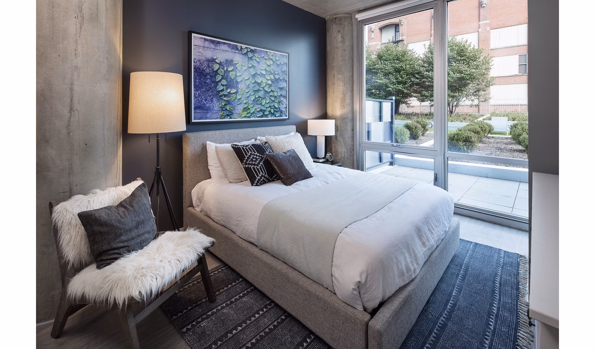Luxurious bedroom with modern furnishings at 1401 S State Apartments, featuring plush bedding and city views
