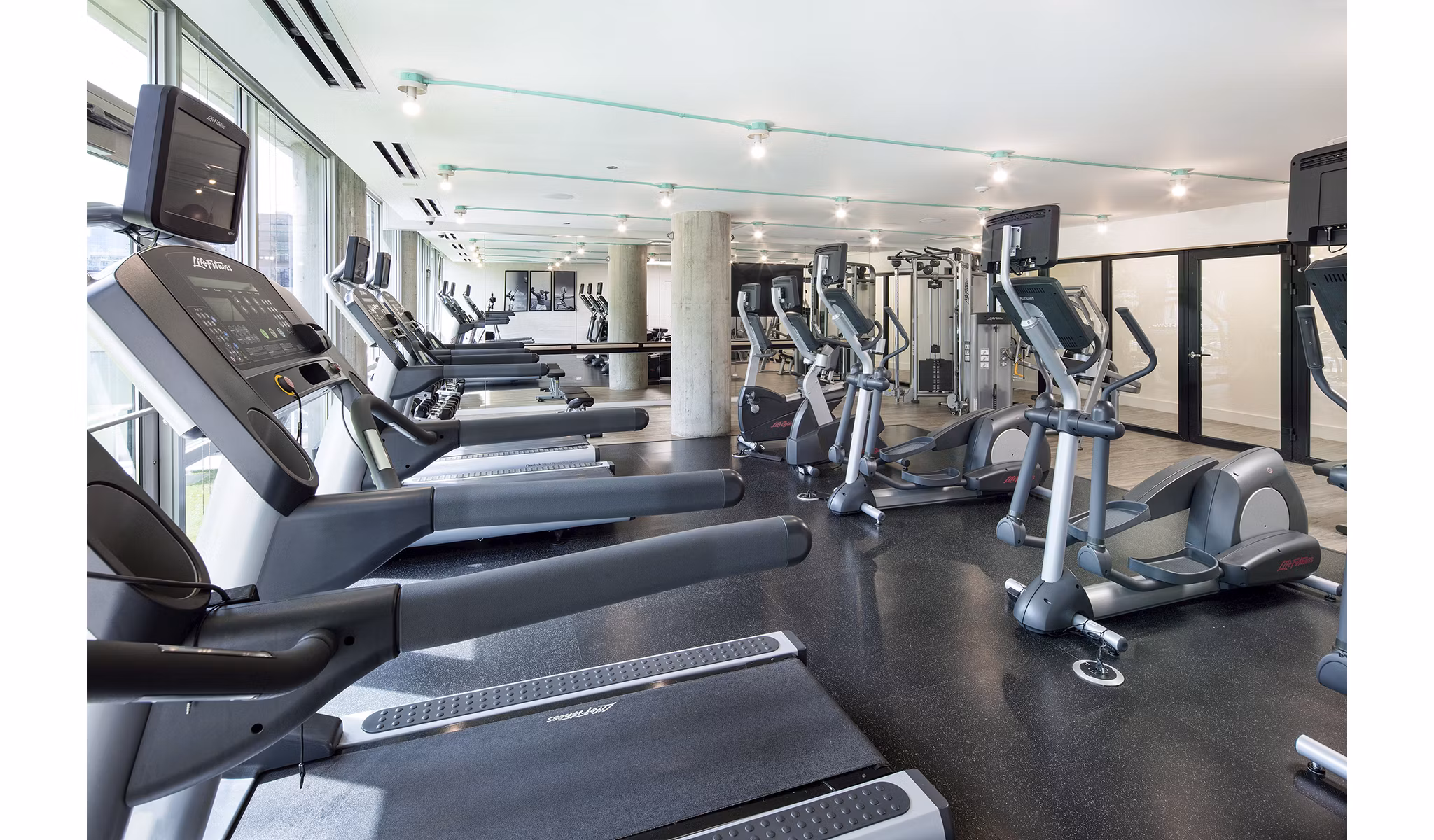 State-of-the-art fitness center with modern equipment at 1401 S State Apartments, ideal for luxury health and fitness enthusiasts