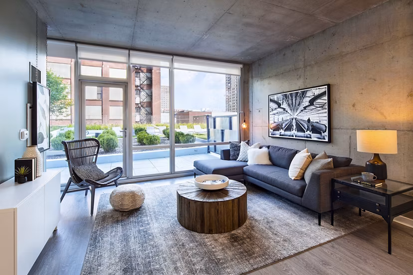 Modern living room featuring sleek furniture and ample natural light at 1401 S State Apartments, offering luxury urban living in Chicago