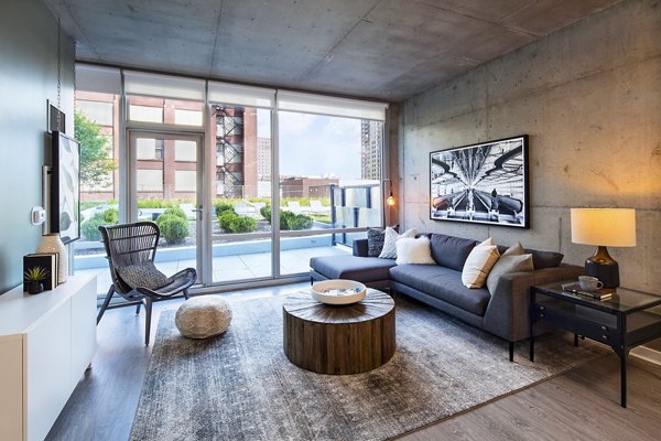 Modern living room featuring sleek furniture and ample natural light at 1401 S State Apartments, offering luxury urban living in Chicago