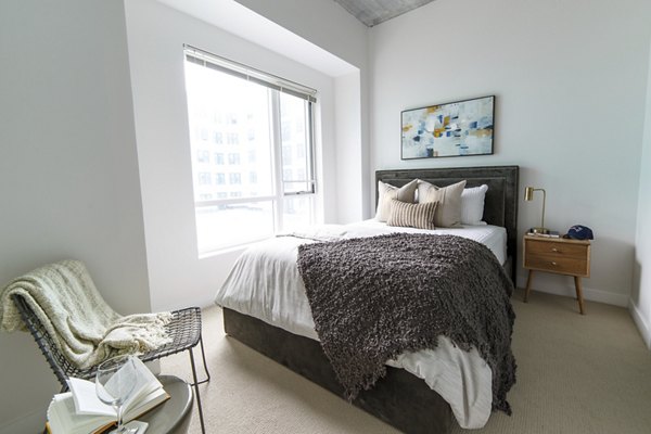 Stylish bedroom with modern decor at Montaje Apartments, showcasing comfort and elegance for luxurious living in a prime location