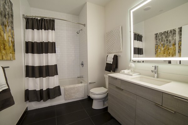 Contemporary bathroom with glass shower and marble vanity in Montaje Apartments