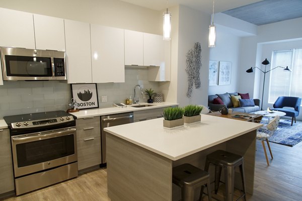 Modern kitchen with stainless steel appliances in Montaje Apartments