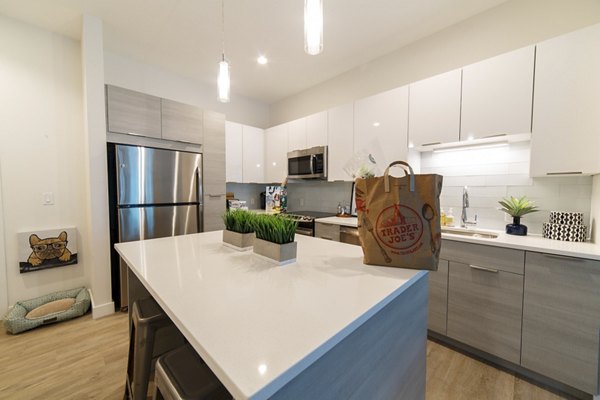 Modern kitchen with stainless steel appliances in Montaje Apartments