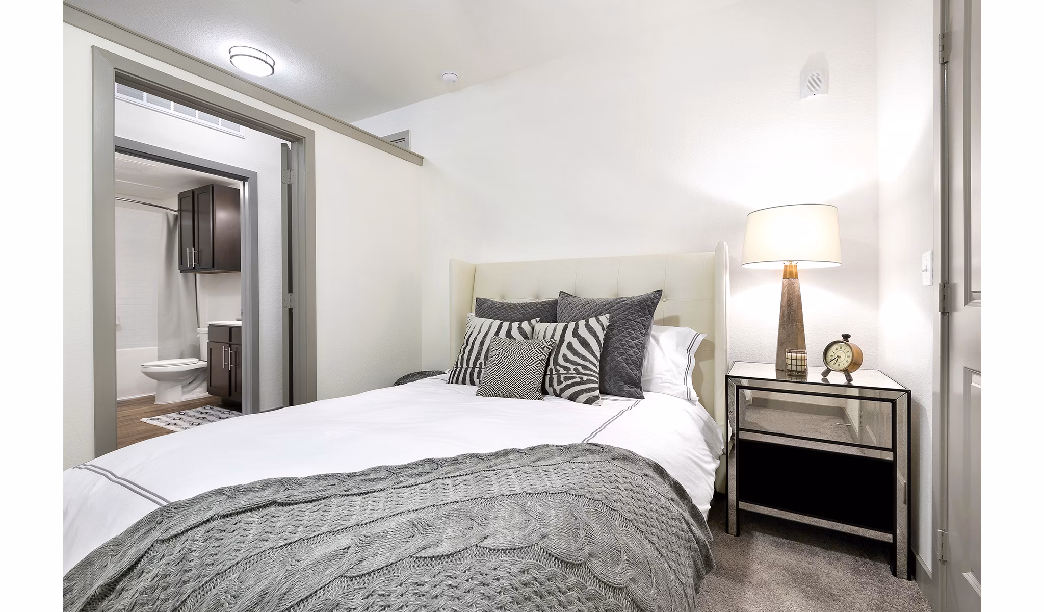 Cozy bedroom with modern furnishings and ample natural light at West Koenig Flats Apartments