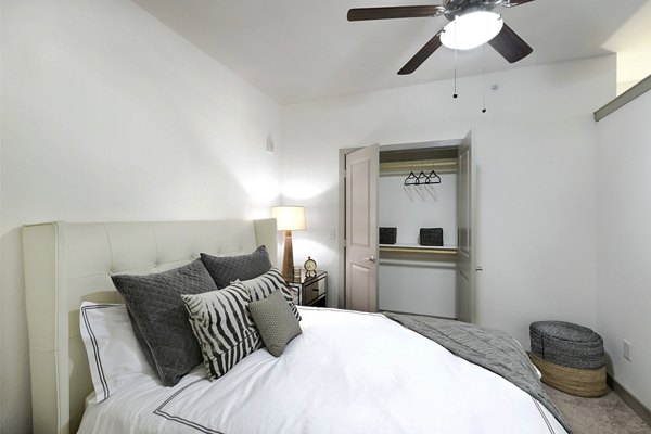 Inviting bedroom with modern dÃ©cor and large windows in West Koenig Flats Apartments