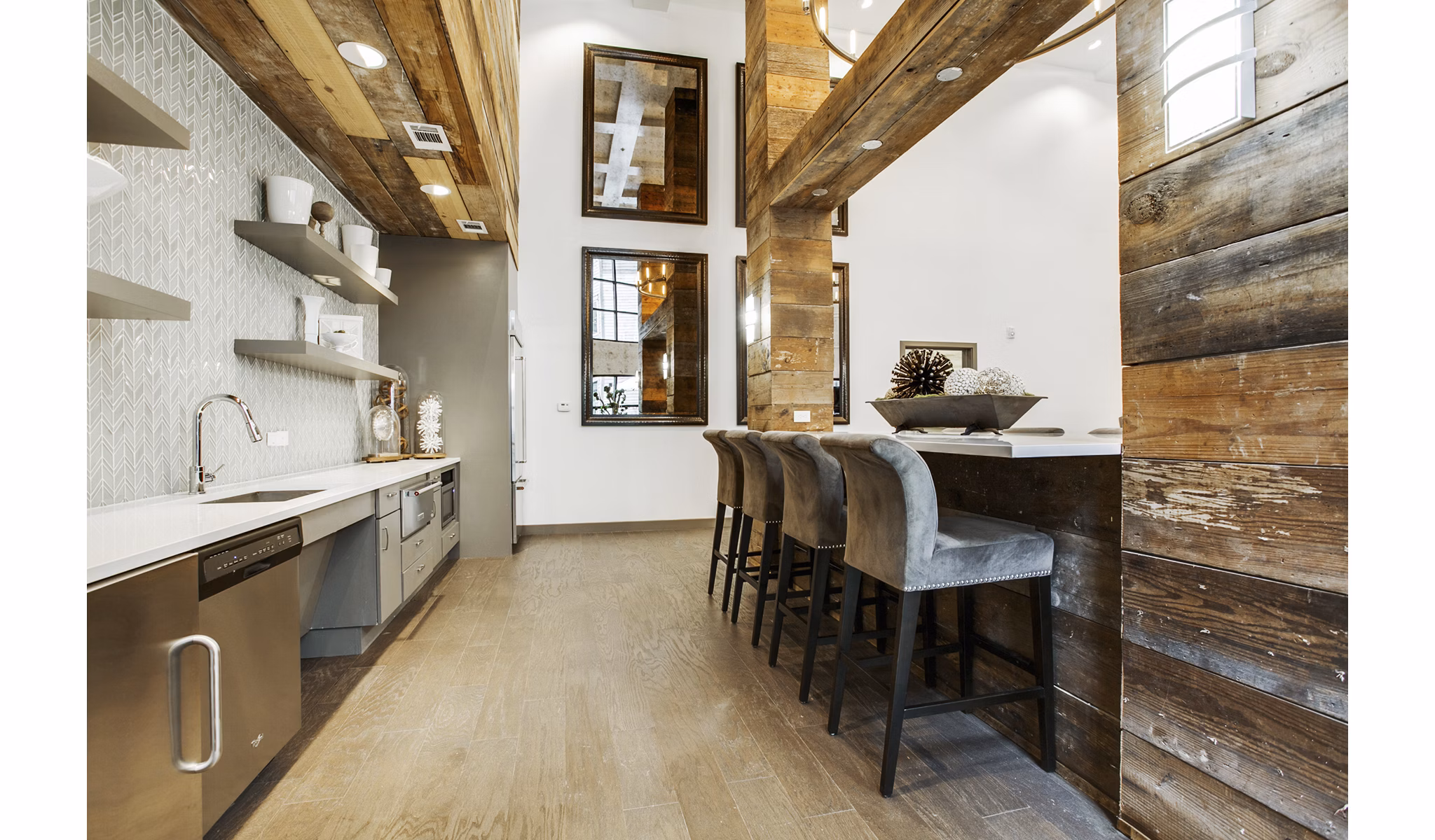 Stylish clubhouse bar at West Koenig Flats Apartments with modern seating and lighting, perfect for social gatherings and relaxation