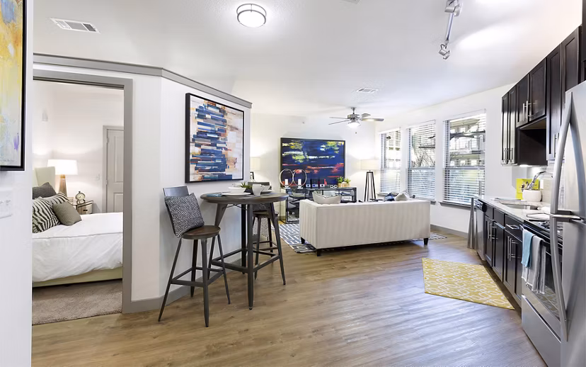 Elegant dining room with hardwood floors and modern decor at West Koenig Flats Apartments