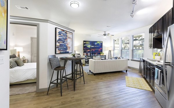 Elegant dining room with hardwood floors and modern decor at West Koenig Flats Apartments