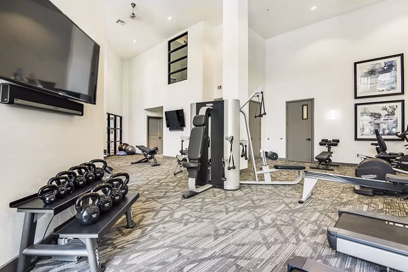 Modern fitness center with state-of-the-art equipment at West Koenig Flats Apartments