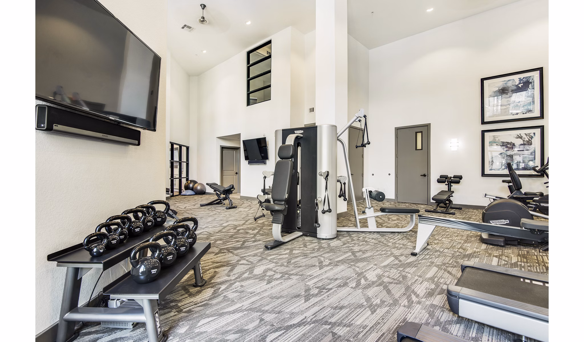 Modern fitness center with state-of-the-art equipment at West Koenig Flats Apartments