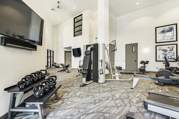 Modern fitness center with state-of-the-art equipment at West Koenig Flats Apartments