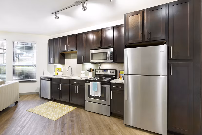 Modern kitchen with stainless steel appliances at West Koenig Flats Apartments in Austin, designed for stylish living