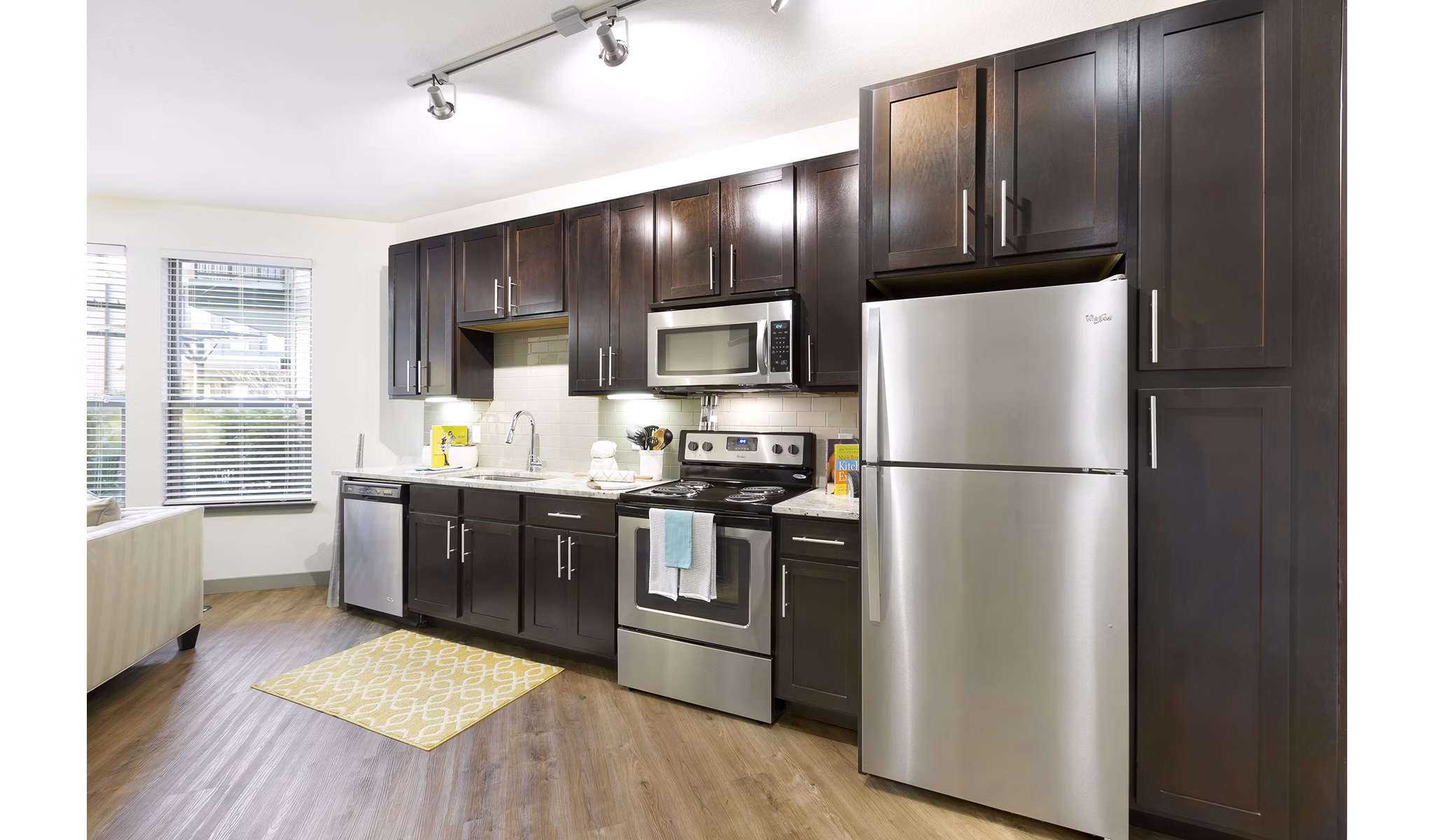 Modern kitchen with stainless steel appliances at West Koenig Flats Apartments in Austin, designed for stylish living