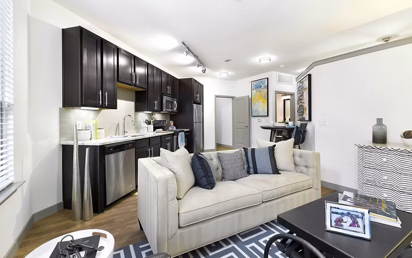 Spacious living room with modern decor in West Koenig Flats Apartments