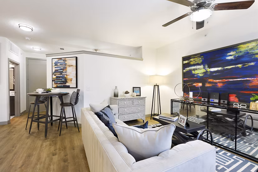 Spacious living room with modern decor at West Koenig Flats Apartments