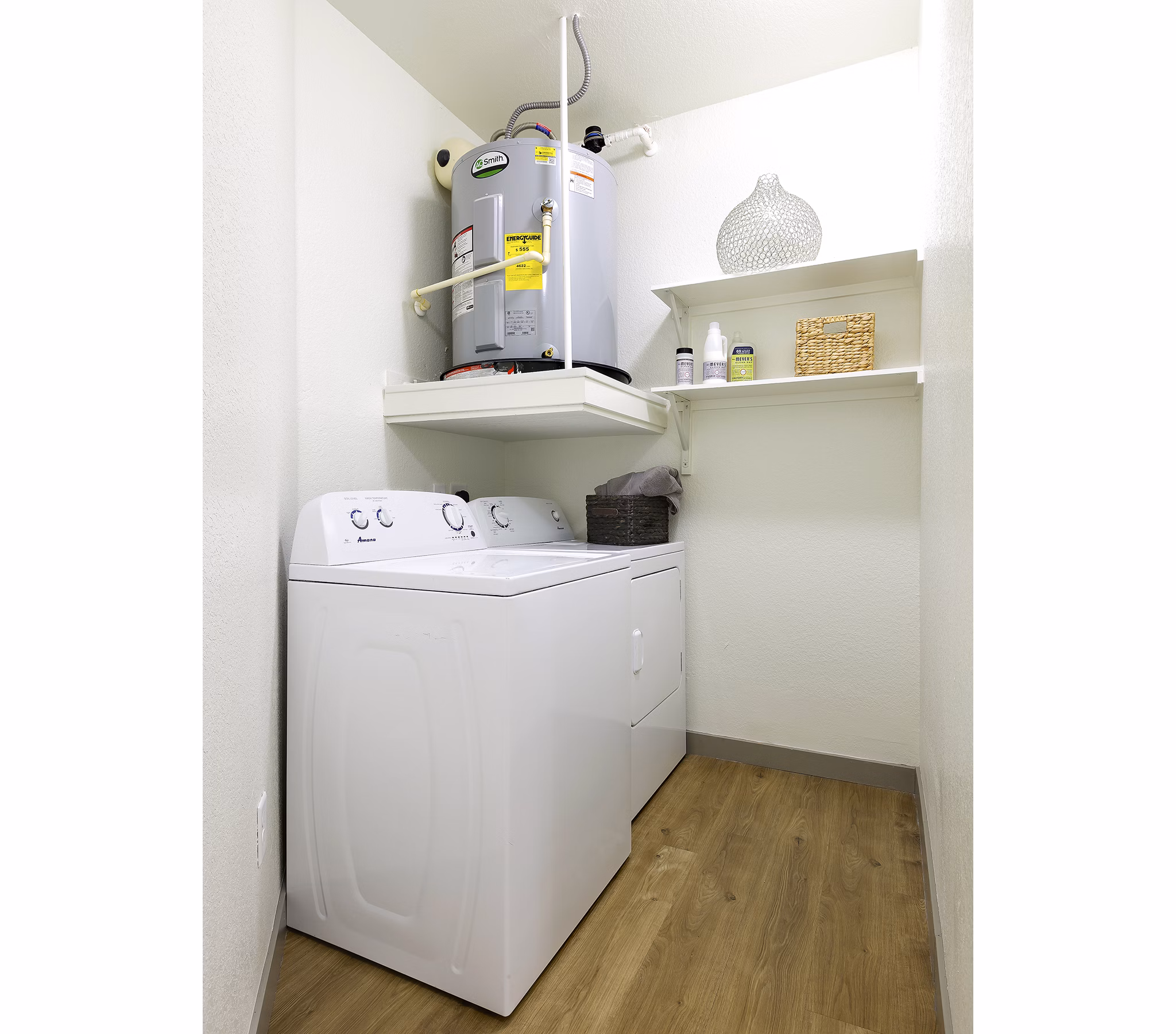 Laundry room with modern appliances and ample storage at West Koenig Flats Apartments