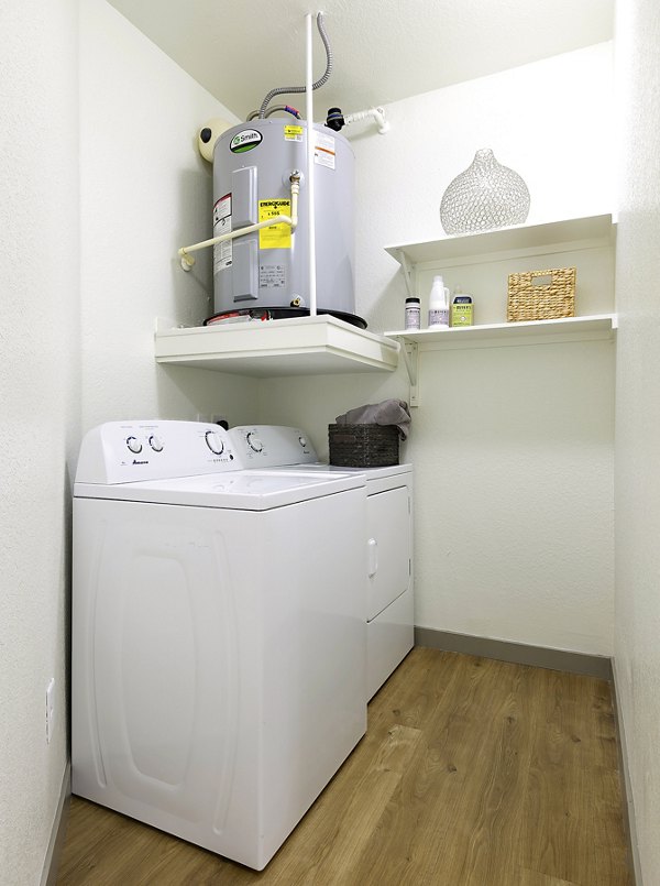 Laundry room with modern appliances and ample storage at West Koenig Flats Apartments
